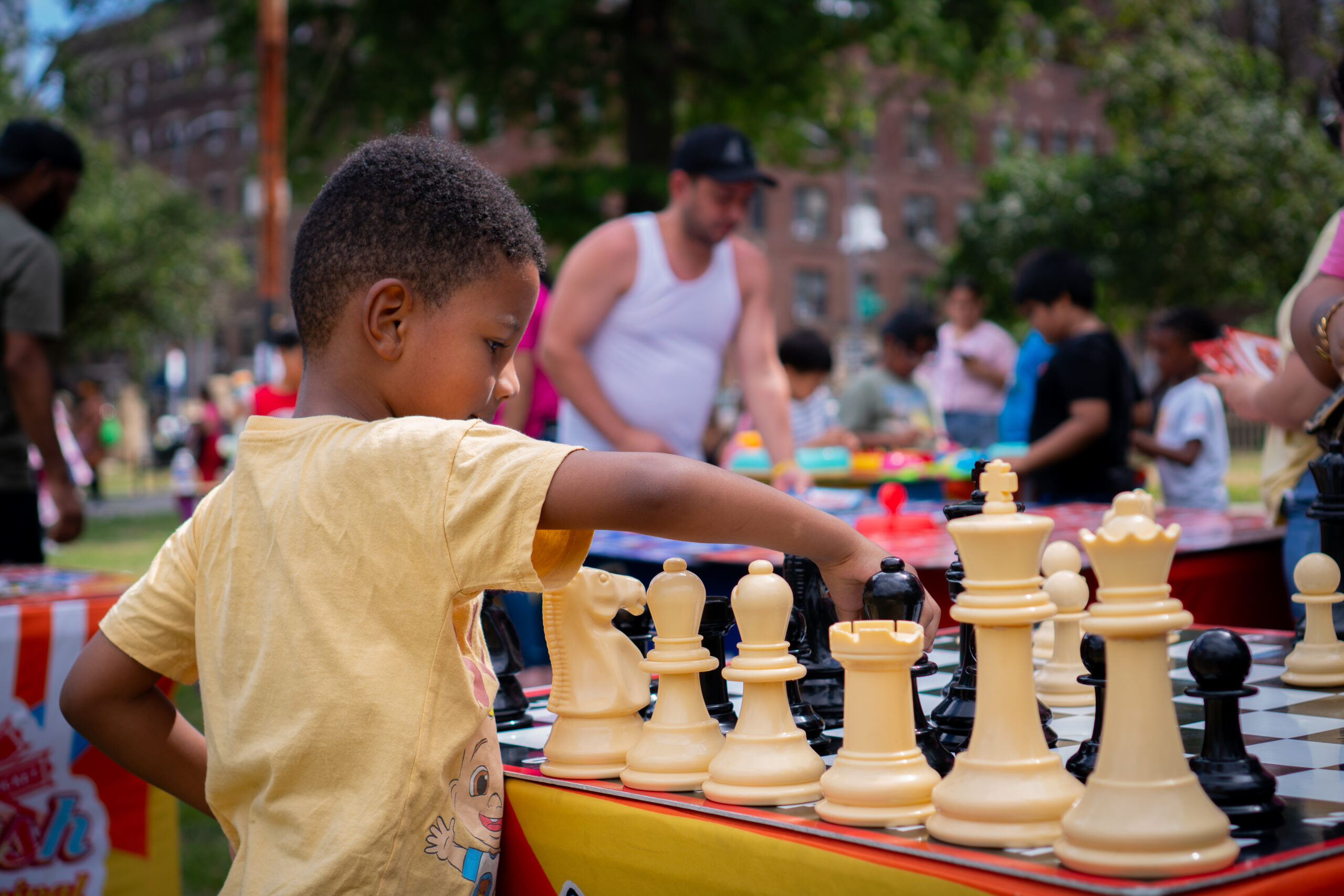 Boy playing chess game at CFR's 2025 Family Fun Day