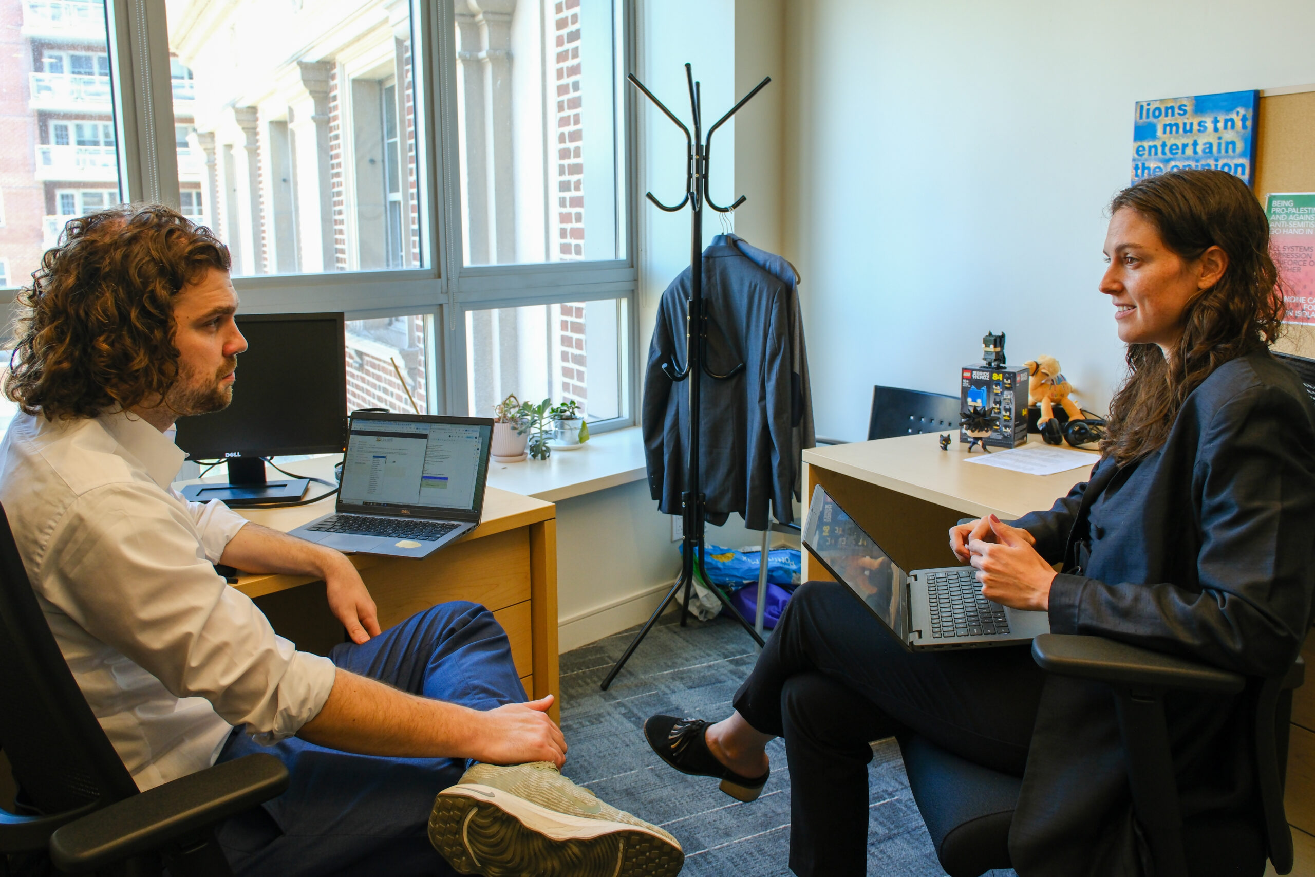 Two CFR staff members talking in an office
